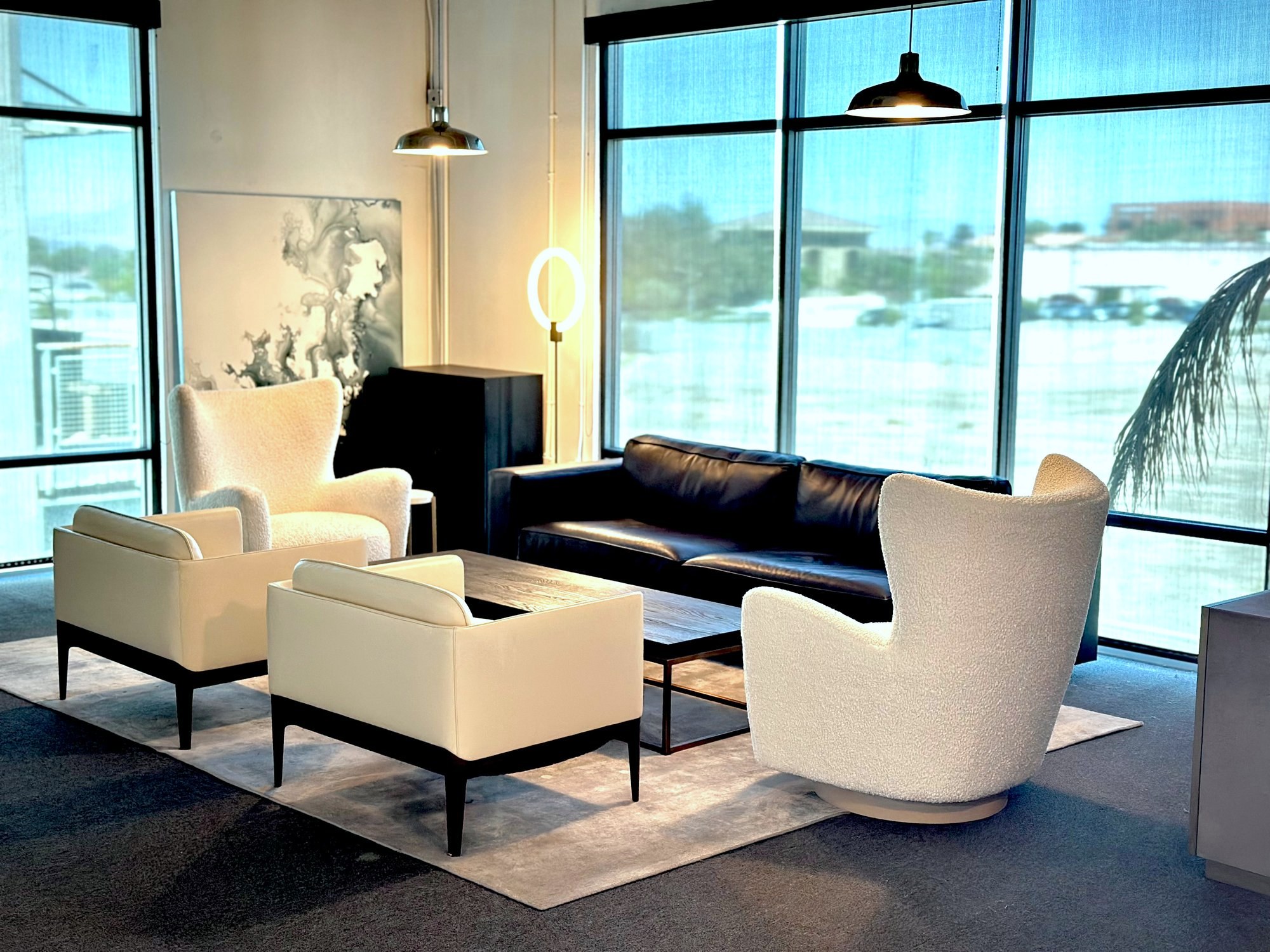 The Uptown Loft &mdash; upstairs lounge with couch and four white chairs.