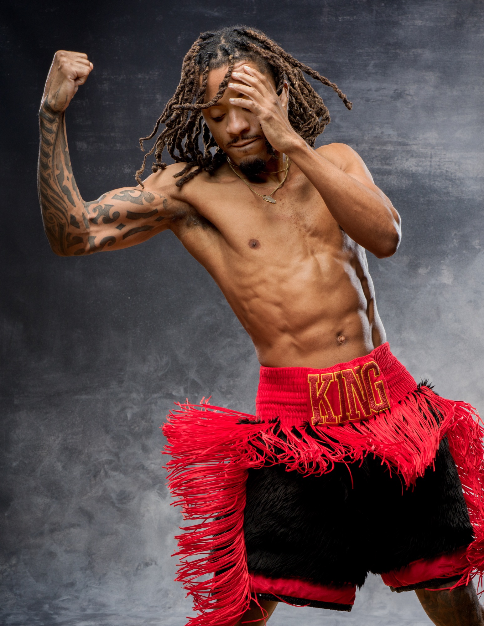 Boxer in red KING shorts mid-pose, gloves, by G. John Slagle.